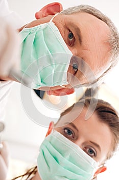 Dentist, Assistant and drill in a treatment