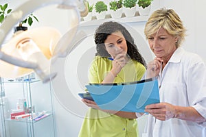 Dentist and assistant looking at dental x-ray