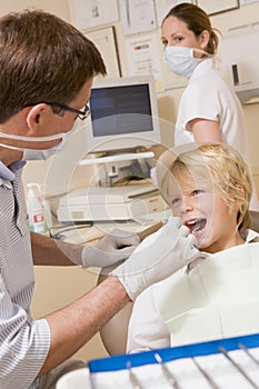 Dentist and assistant with young boy