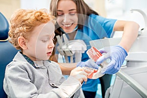 Dentist with boy at the dental office