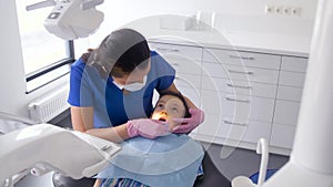 Dentist checking for kid teeth at dental clinic