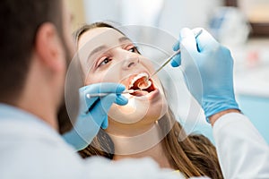 Dentist checking patient teeth