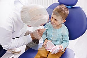 Dentist checking up child patient