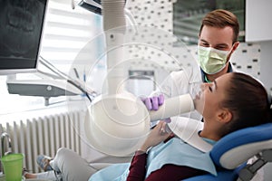 Dentist checking up womanâ€™s teeth