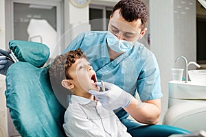 Dentist checks the child`s teeth