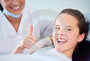 Dentist, child and portrait with thumbs up with teeth cleaning or cavity treatment for oral hygiene, healthy or