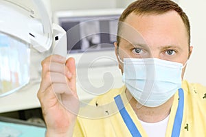 Dentist clings to lamp in dental clinic