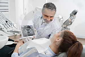 Dentist consulting patient about dental x-ray.