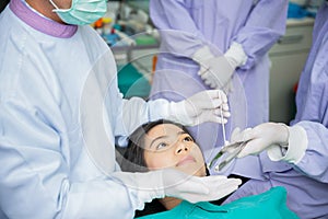 Dentist curing a asian female