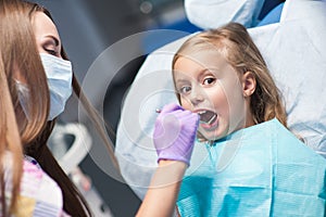 Dentist curing a child patient in the dental office