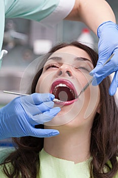 Dentist curing a female patient