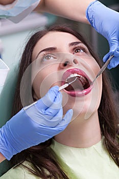 Dentist curing a female patient