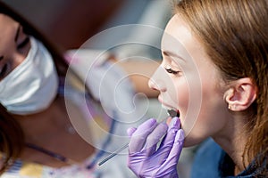 Dentist curing a woman patient