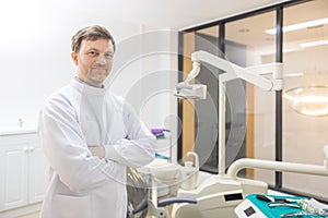 Dentist demonstrating a jaw model and a dental instrument. The notion of oral hygiene