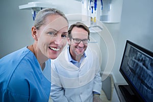 Dentist and dental assistant discussing a x-ray on the monitor
