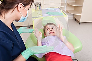 Dentist doctor calming scared kid patient photo