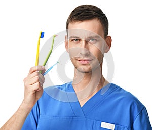 Dentist doctor dental hygienists compare tooth brushes to brush teeth