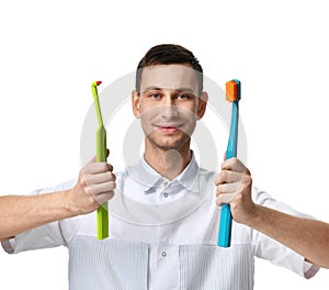 Dentist doctor dental hygienists compare two big tooth brushes