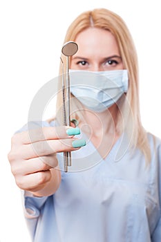 Dentist doctor female holding dental tools
