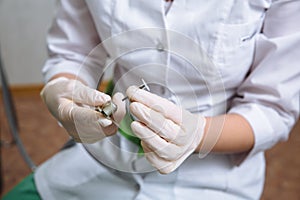 Dentist doctor hand holding medical tools in dental office. Concept of healthy