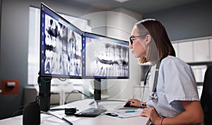 Dentist Doctor Looking At Teeth Xray