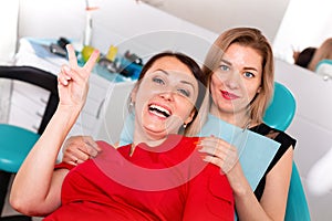 Dentist doctor poses for the camera on the background of the dental office with the patient. Concept healthy teeth