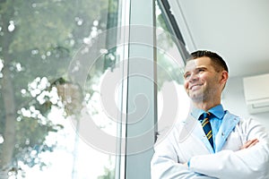 Dentist Doctor Stands Near Window and Thinks about Clinic Future