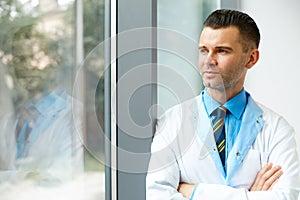 Dentist Doctor Stands Near Window and Thinks about Clinic Future