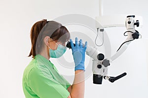 Dentist doctor using dental microscope.