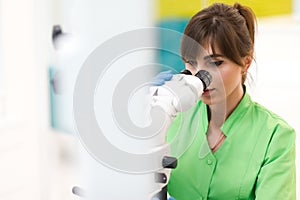 Dentist doctor using dental microscope.