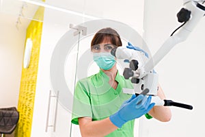 Dentist doctor using dental microscope.