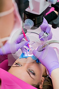 Dentist doctor using dental microscope in modern dental office