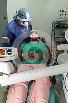 Dentist doing a dental check up on a patient at his dental clinic