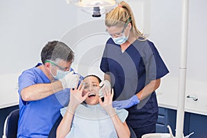 Dentist doing injection and patient protesting