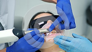 Dentist is doing intraoral scanning for woman before installing ceramic crowns.