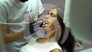 Dentist drill teeth clinic client. stomatologist, dentist treats teeth of the young client`s dental drill. Dental