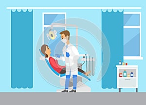 Dentist with equipment examining teeth. Female patient lying in dental chair in medical clinic