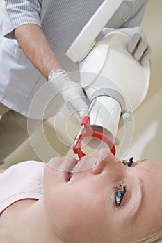 Dentist in exam room with woman in chair