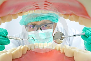 Dentist examine oral cavity with dental tool