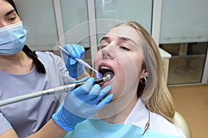 The dentist examines the patient`s teeth in the dental office