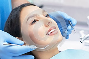 Dentist examines the patients teeth