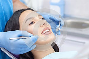 Dentist examines the patients teeth