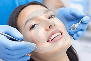 Dentist examines the patients teeth