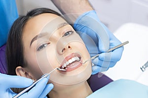 Dentist examines the patients teeth