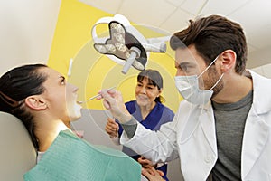 dentist examining beautiful patient in dentists office