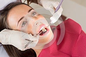 Dentist examining a female patient`s teeth in the dentist office
