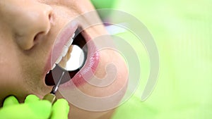 Dentist examining foreteeth examination with mouth mirror, preventive dentistry
