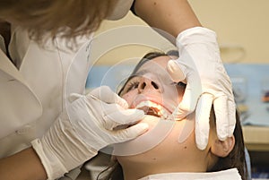 Dentist examining a girl's teeth