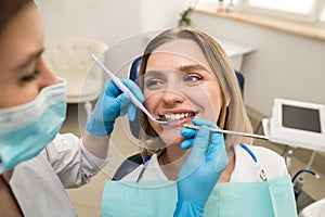 Dentist examining patient`s teeth