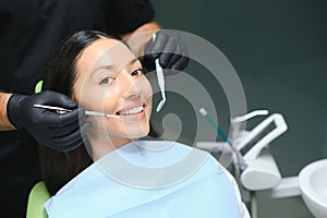 Dentist examining patient's teeth, close up